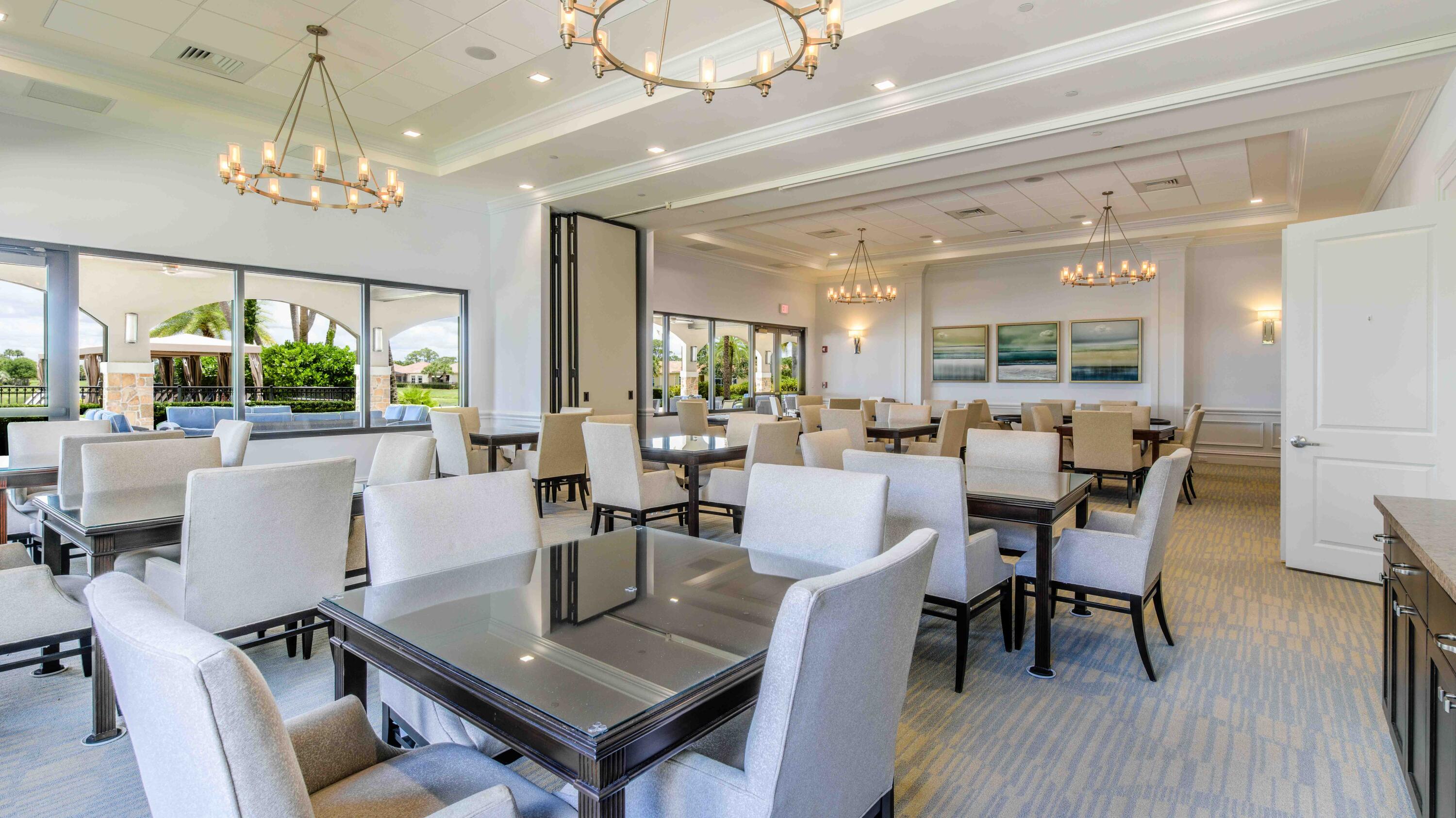 11473 Southwest Visconti Way Port St. Lucie, FL 34986 - Photo 51 of 69 a view of a dining room with furniture a chandelier and wooden floor