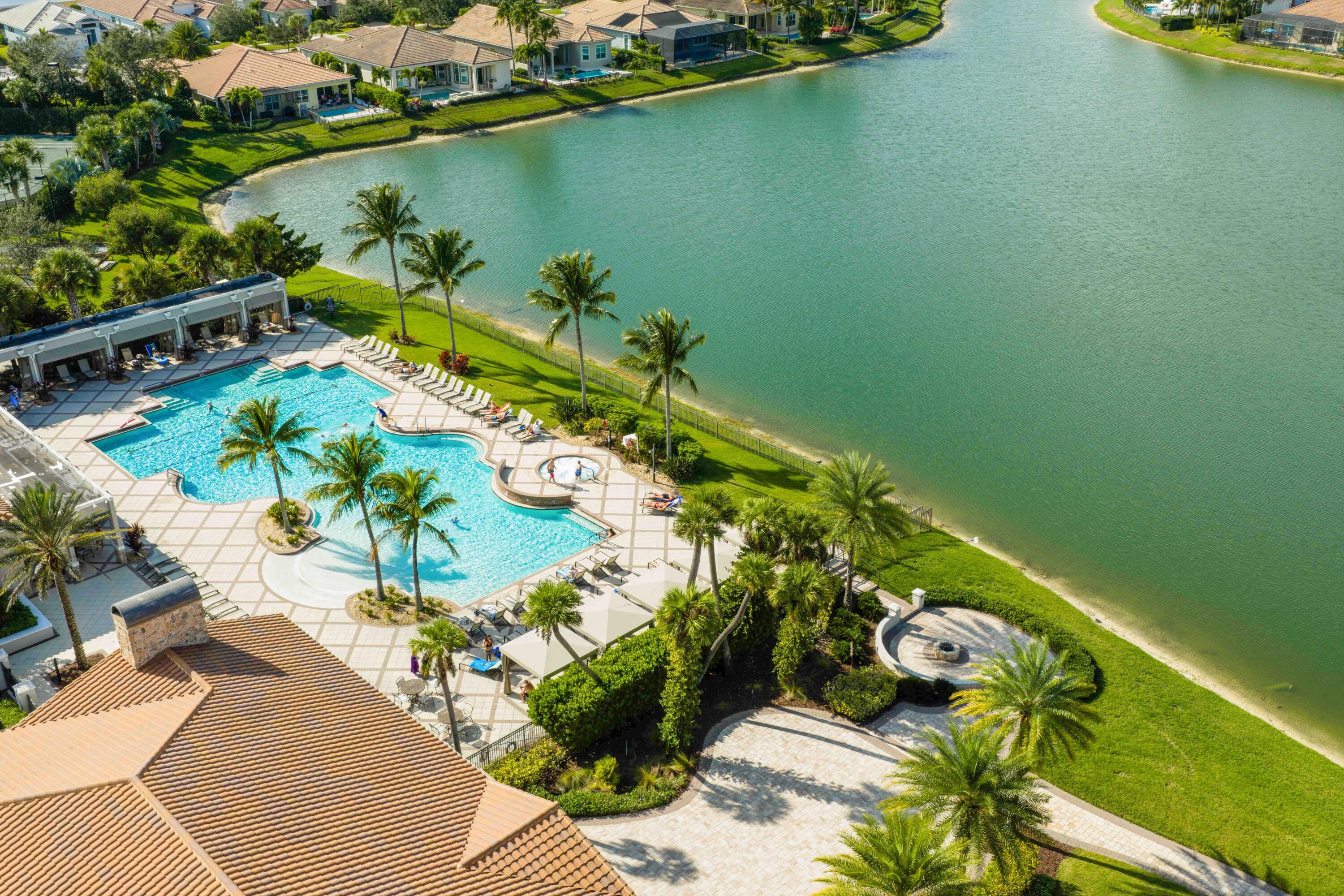 11473 Southwest Visconti Way Port St. Lucie, FL 34986 - Photo 68 of 69 view of a lake with a floor to ceiling window and potted plants