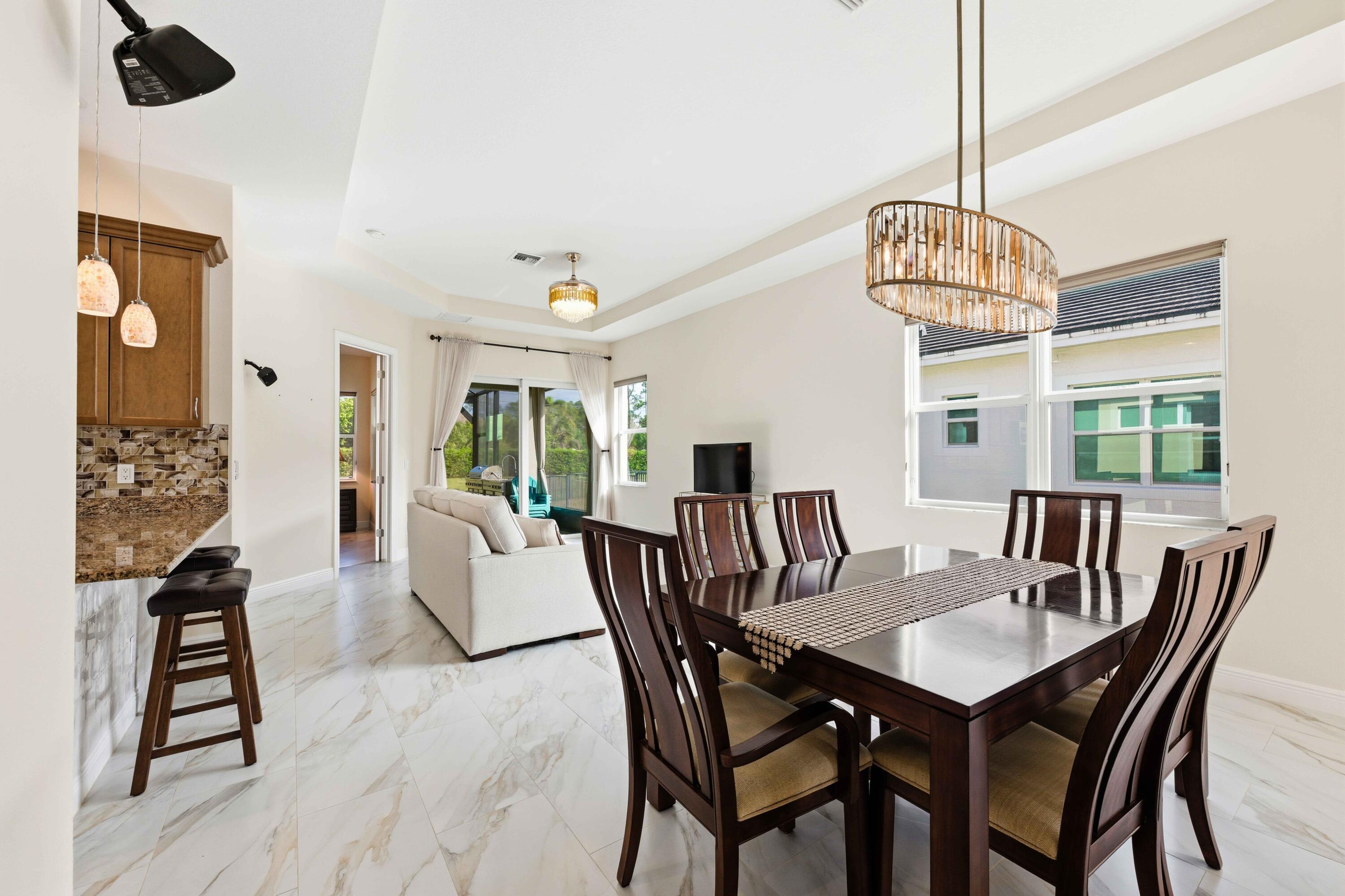 11473 Southwest Visconti Way Port St. Lucie, FL 34986 - Photo 7 of 69 a view of a dining room with furniture window and wooden floor