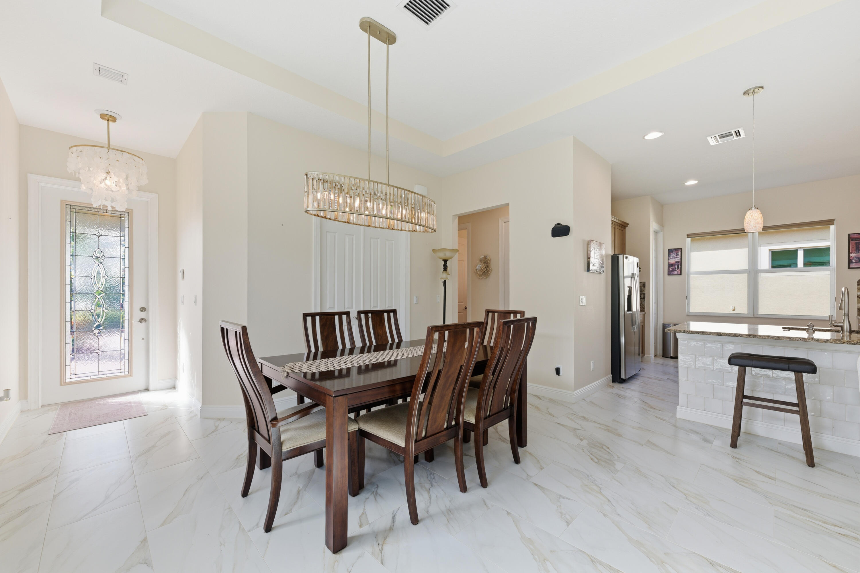 11473 Southwest Visconti Way Port St. Lucie, FL 34986 - Photo 10 of 69 a view of a dining room with furniture and wooden floor