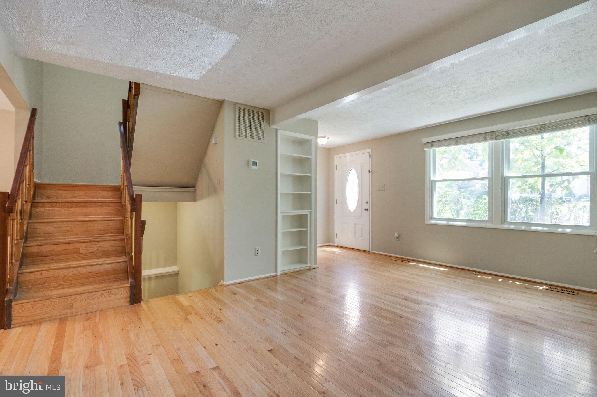 8044 Steeple Chase Court Springfield, VA 22153 - Photo 10 of 25 Built-Ins, Hardwood Floors, and Open Staircases