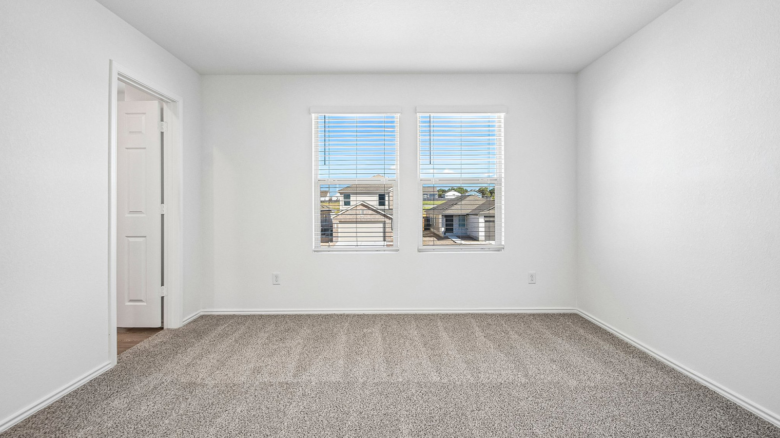 388 Old Stage Coach Road Jarrell, TX 76537 - Photo 16 of 30 Plush carpeting and dual windows overlooking the neighborhood anchor this versatile secondary bedroom.