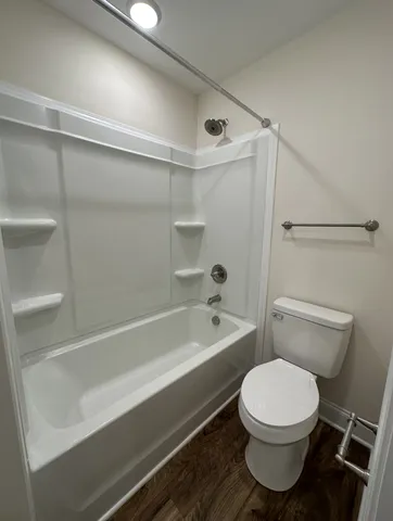 a bathroom with a toilet and a bath tub