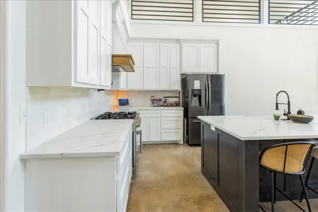 a kitchen with a sink cabinets and window
