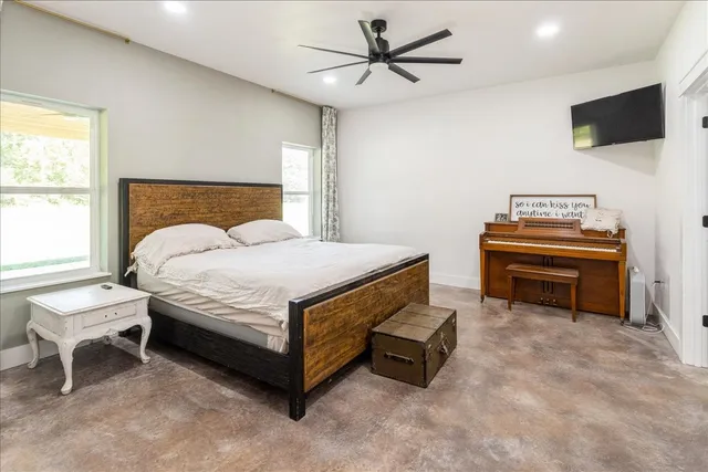 a bedroom with a bed and a flat screen tv