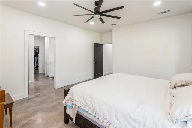 a bedroom with a bed and a ceiling fan