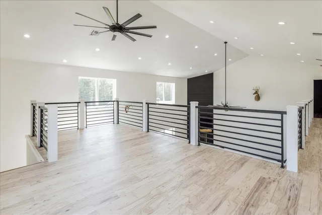 a view of a room with wooden floor