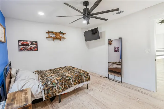 a bedroom with a bed and a chandelier