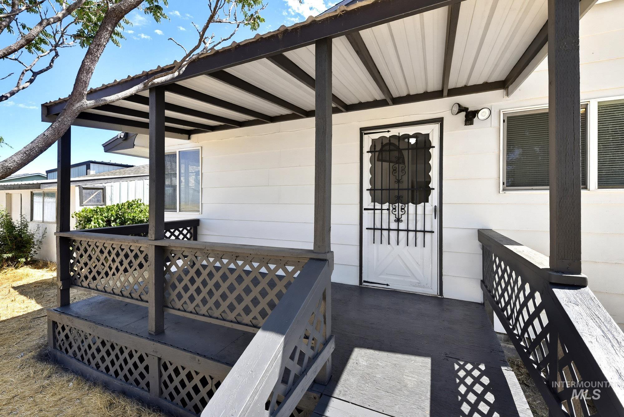 5755 Chuckwagon Road Nampa, ID 83686 - Photo 39 of 50 Covered porch entry featuring a metal roof and painted wood railings