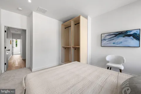 a bedroom with a bed and a lamp on table
