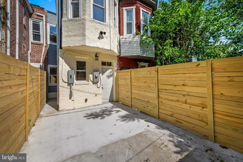a view of a house with a wooden fence