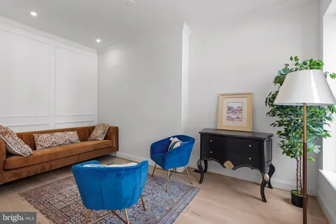 a living room with furniture a couch and a potted plant
