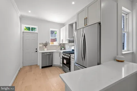 a kitchen with a refrigerator sink and stove