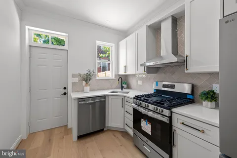 a kitchen with cabinets appliances and a window