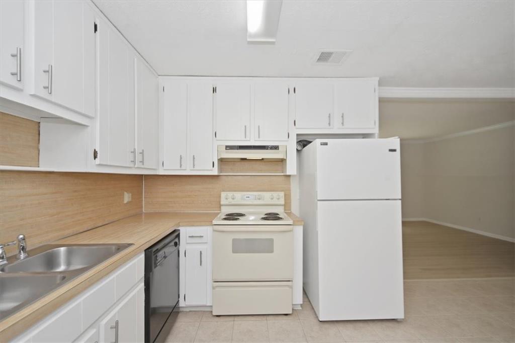 142 Deer Run Canton, GA 30114 - Photo 16 of 24 a white refrigerator freezer sitting inside of a kitchen