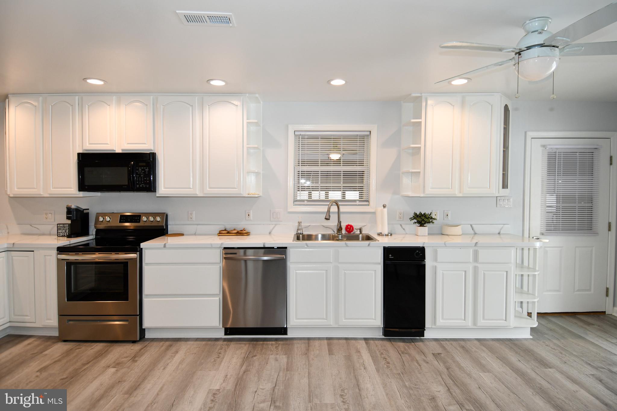 10049 Meleen Drive Faulkner, MD 20632 - Photo 11 of 56 a kitchen with a sink cabinets and stainless steel appliances