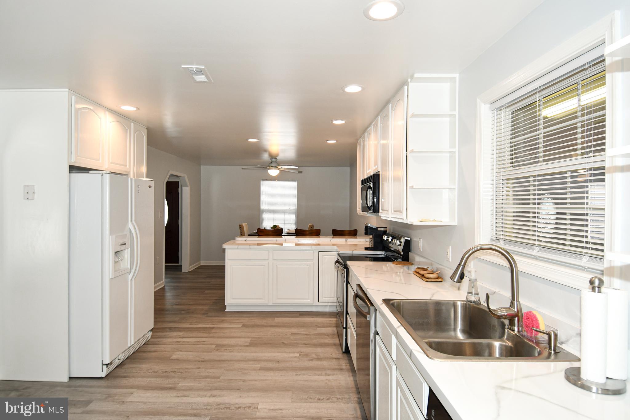 10049 Meleen Drive Faulkner, MD 20632 - Photo 15 of 56 a kitchen with sink a refrigerator and cabinets