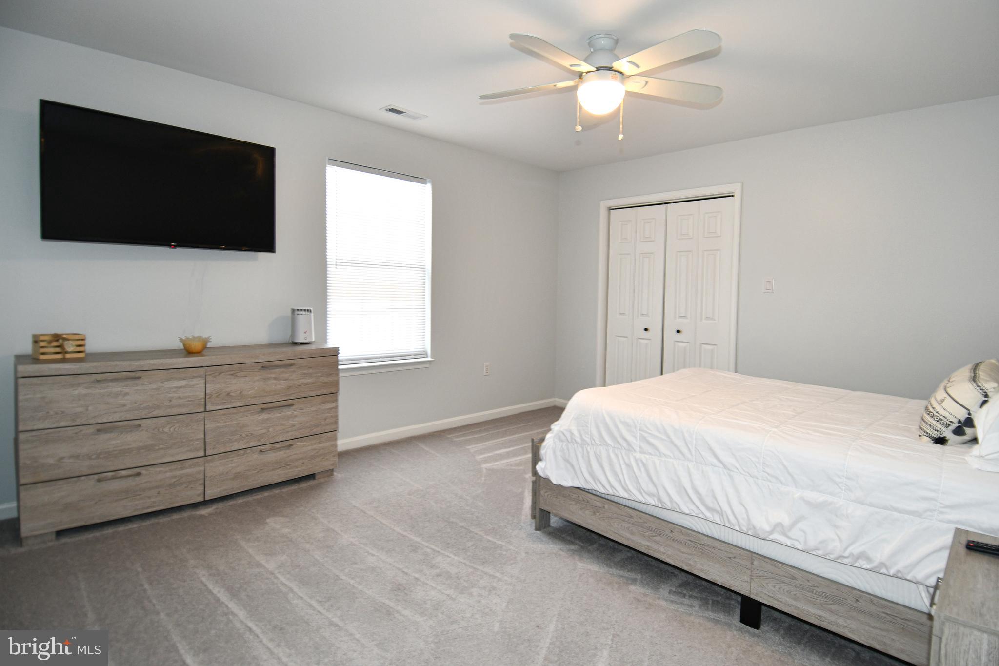 10049 Meleen Drive Faulkner, MD 20632 - Photo 23 of 56 a bedroom with a bed and a flat screen tv
