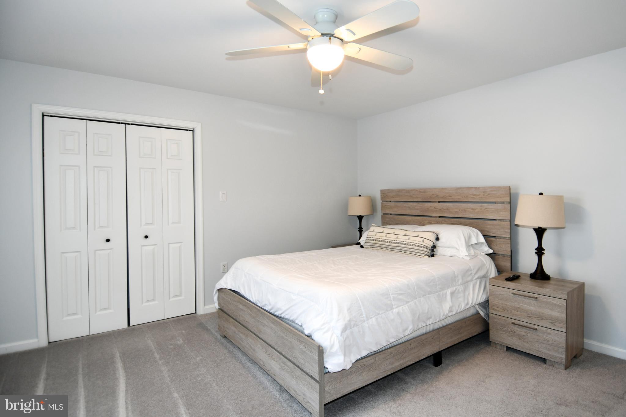 10049 Meleen Drive Faulkner, MD 20632 - Photo 25 of 56 a bedroom with a bed and a chandelier
