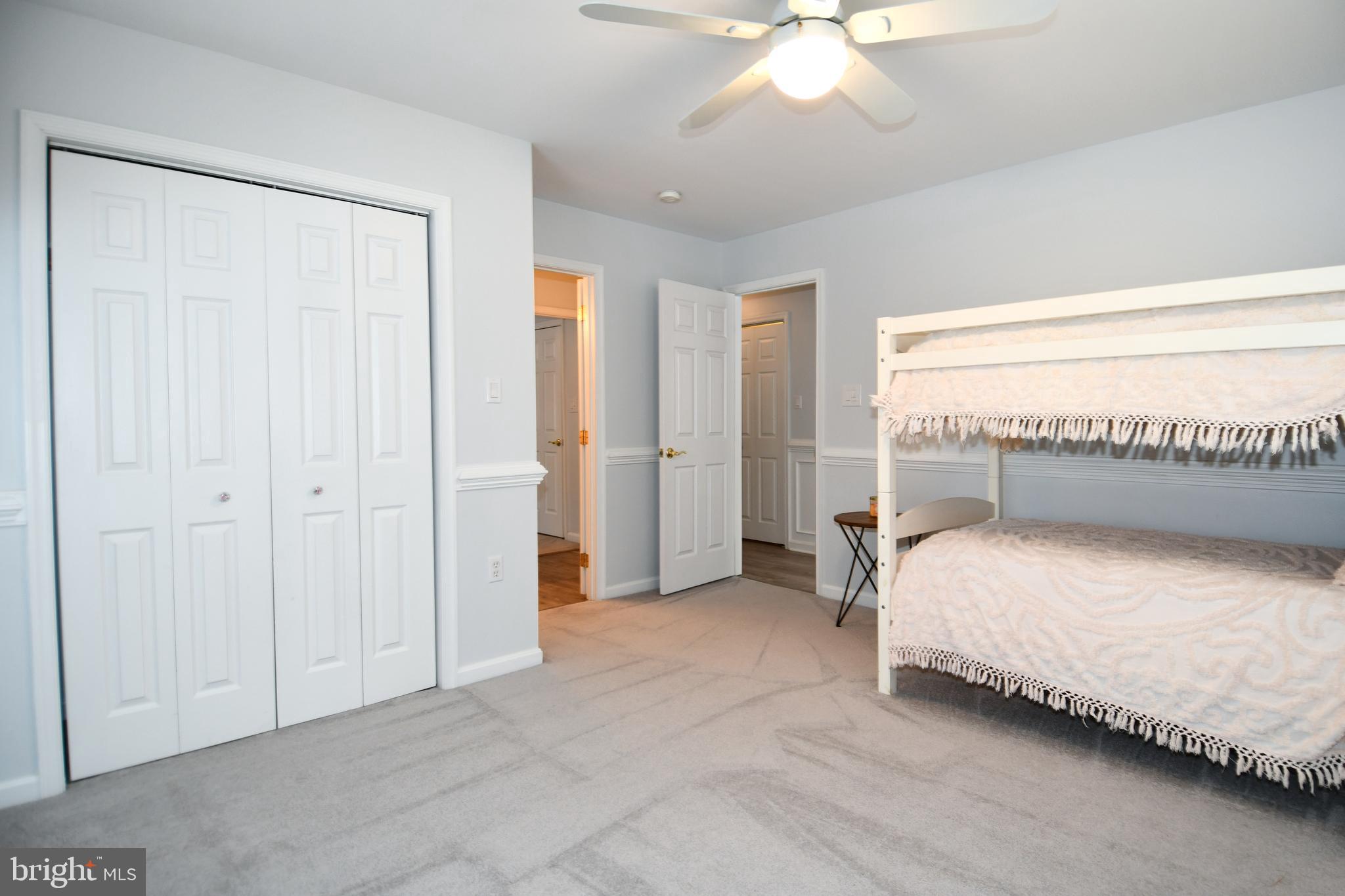 10049 Meleen Drive Faulkner, MD 20632 - Photo 29 of 56 a spacious bedroom with a bed and a chandelier
