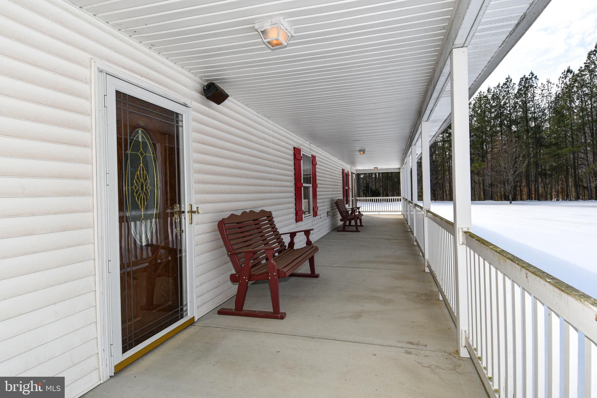 10049 Meleen Drive Faulkner, MD 20632 - Photo 45 of 56 a view of a porch with furniture and yard