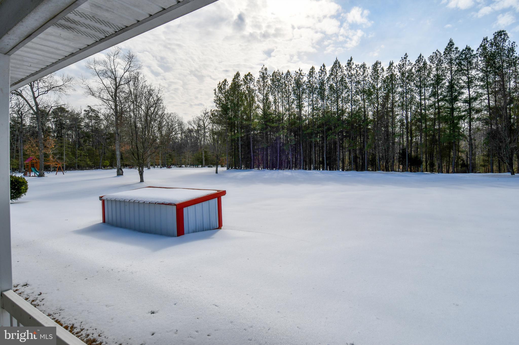 10049 Meleen Drive Faulkner, MD 20632 - Photo 46 of 56 a swimming pool with outdoor seating and trees in the background