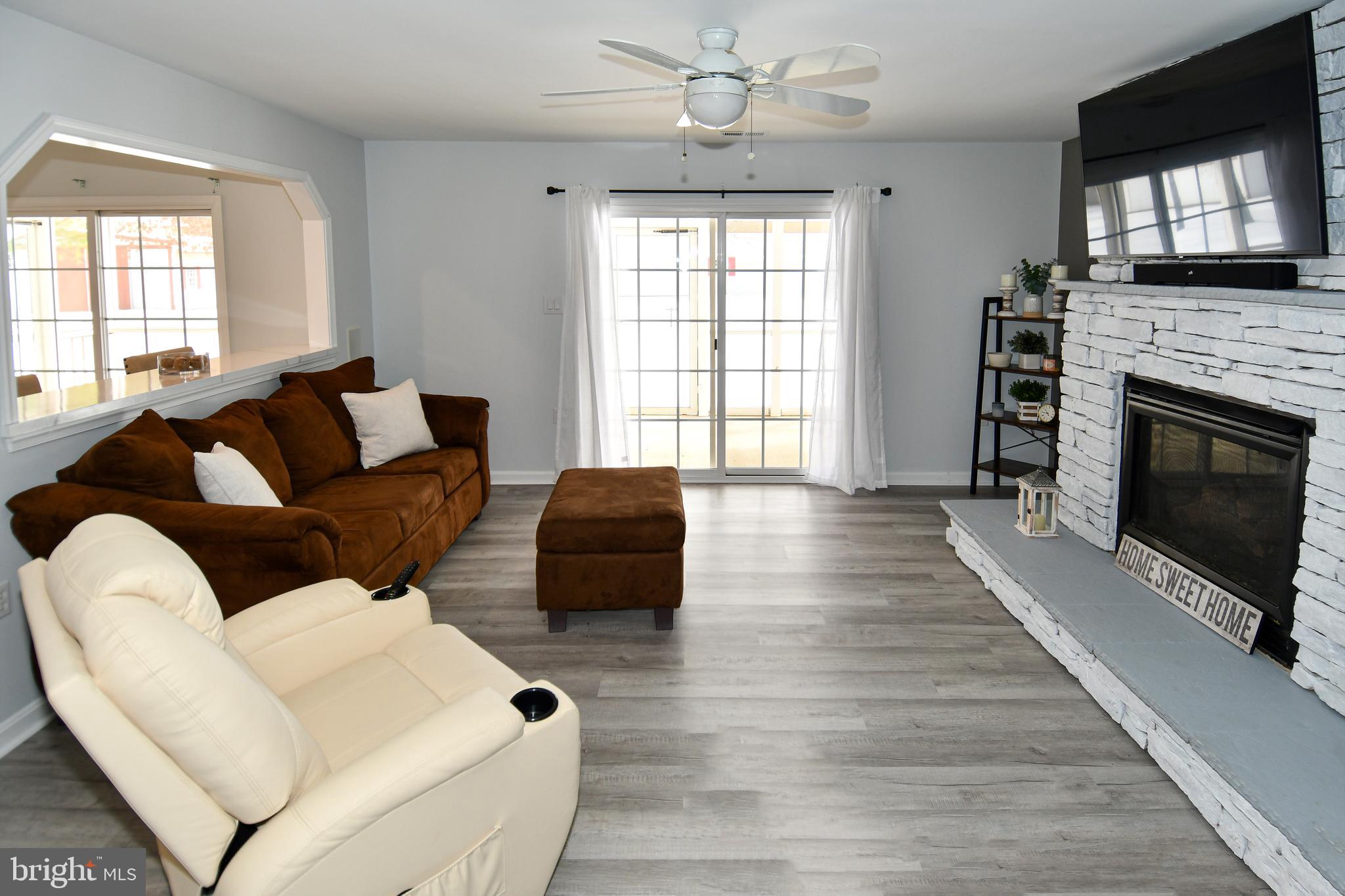 10049 Meleen Drive Faulkner, MD 20632 - Photo 7 of 56 a living room with furniture a flat screen tv and a fireplace
