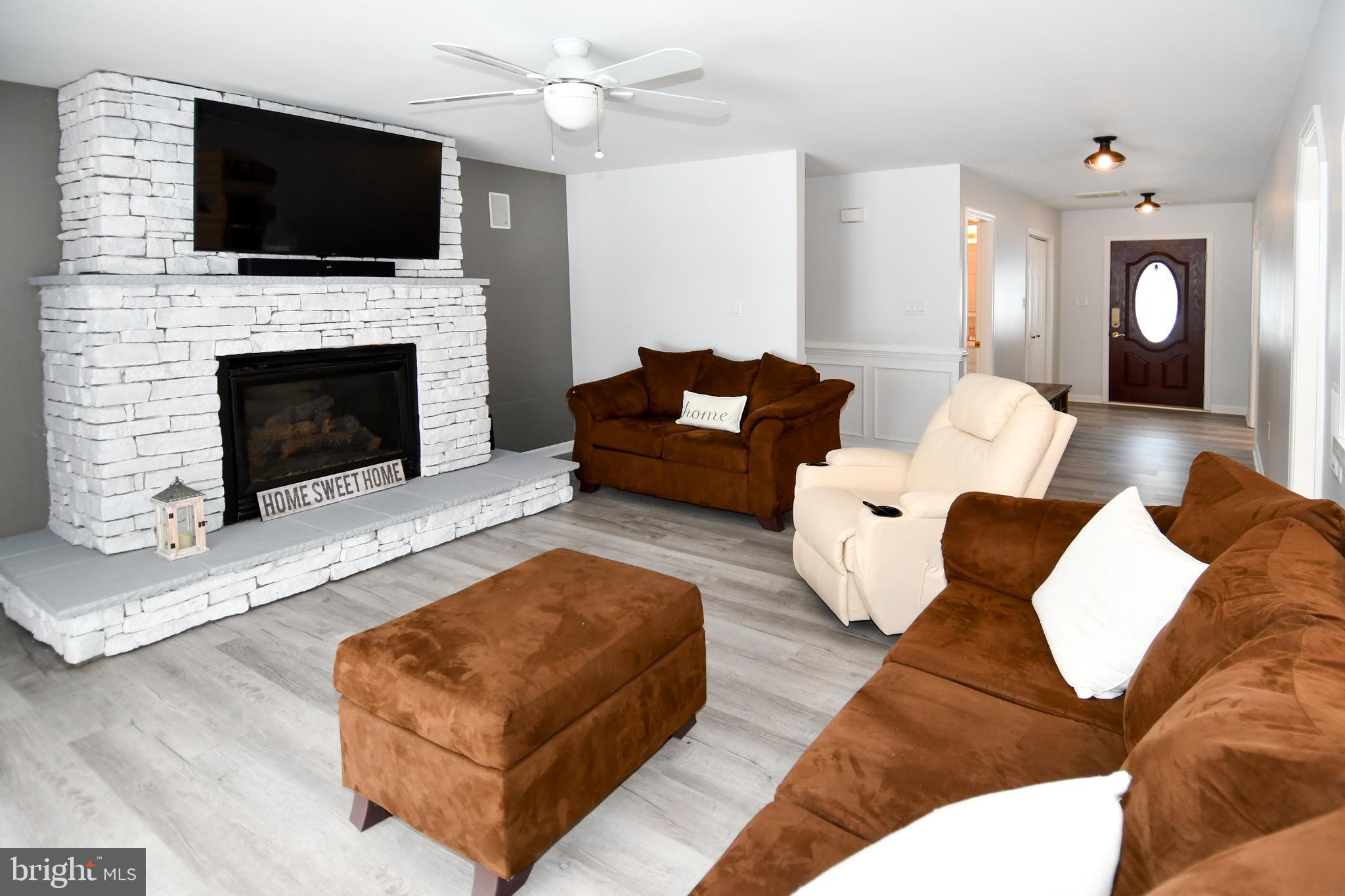 10049 Meleen Drive Faulkner, MD 20632 - Photo 8 of 56 a living room with furniture fireplace and flat screen tv