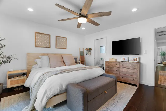 a room with a bed and a flat screen tv