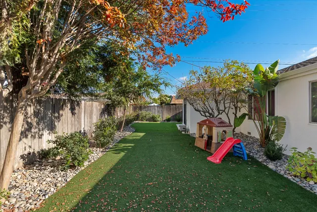 a view of yard with swimming pool and green space