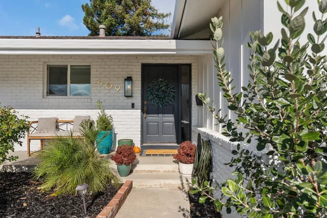 a view of a house with potted plants