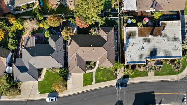 an aerial view of multiple houses with yard