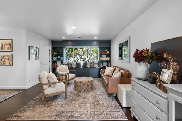 a living room with furniture and flowers