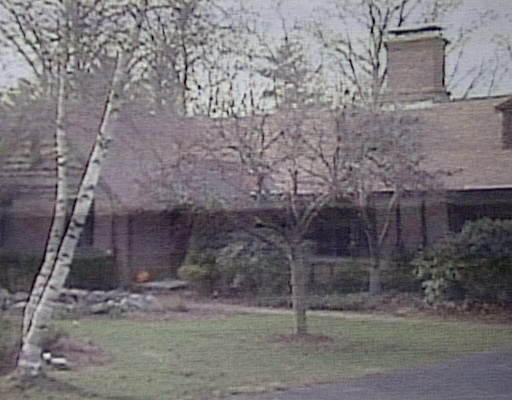 a brick building with a bench in front of it