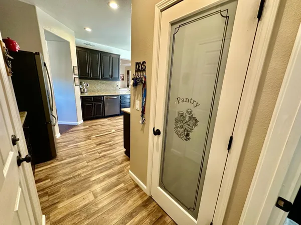 a room with furniture pool table wooden floor and windows