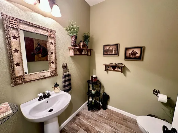 a bathroom with a double vanity sink toilet and shower