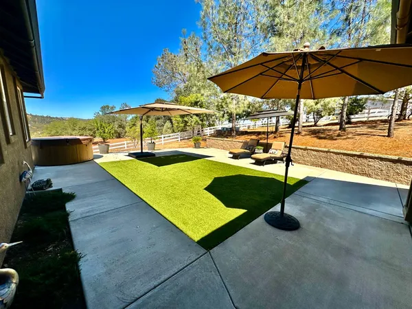 a view of backyard with outdoor seating and trees