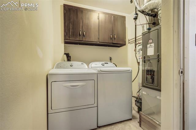 23555 Murphy Road Calhan, CO 80808 - Photo 41 of 49 Washroom featuring cabinets and separate washer and dryer