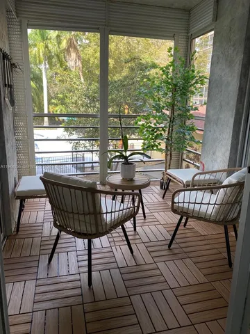 a view of a chairs and table in the balcony