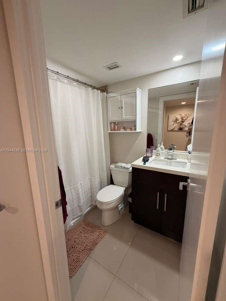 17890 West Dixie Highway, Unit 210 North Miami Beach, FL 33160 - Photo 13 of 19 a bathroom with a sink a toilet and shower