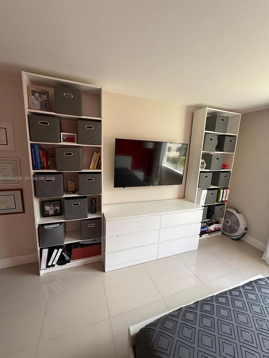 17890 West Dixie Highway, Unit 210 North Miami Beach, FL 33160 - Photo 2 of 19 a view of an empty room with shelves
