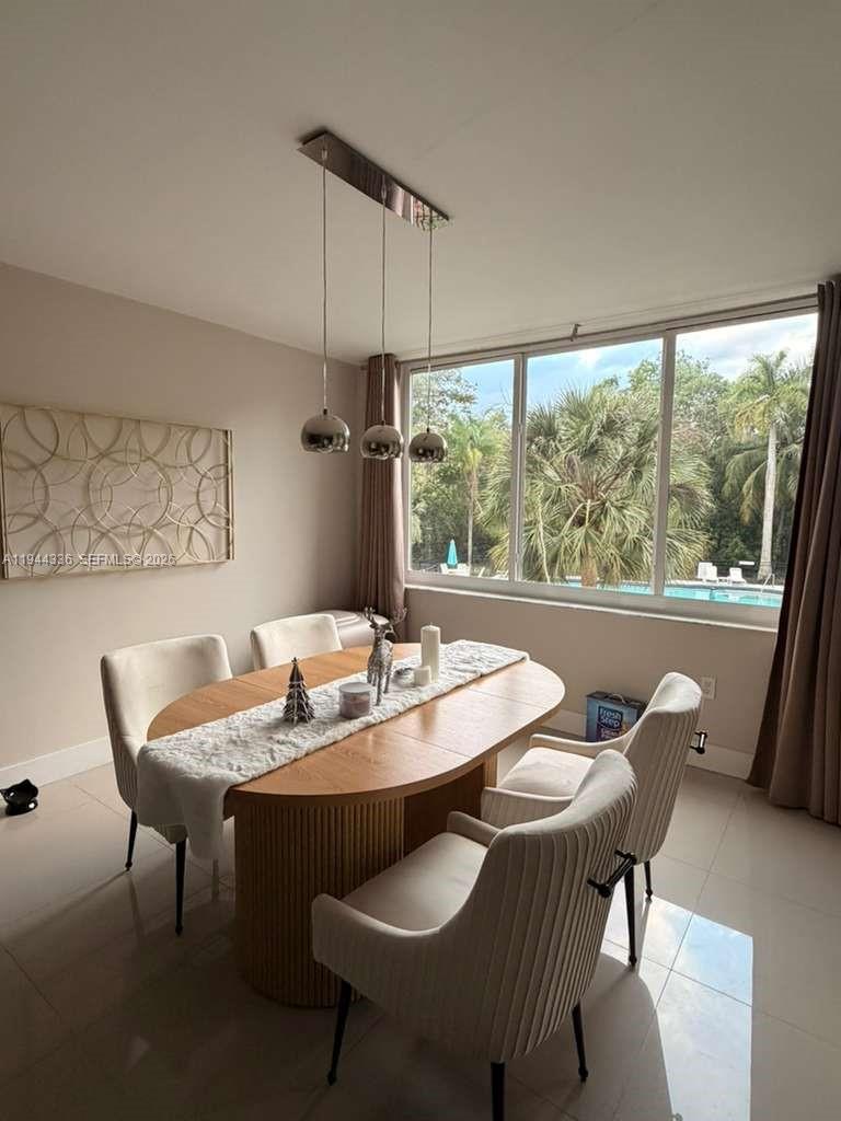 17890 West Dixie Highway, Unit 210 North Miami Beach, FL 33160 - Photo 3 of 19 a dining room with furniture a chandelier and wooden floor