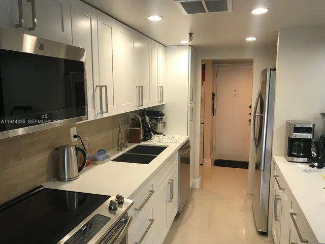 a kitchen that has a sink and a stove in it