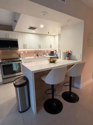a kitchen with a sink cabinets and stainless steel appliances