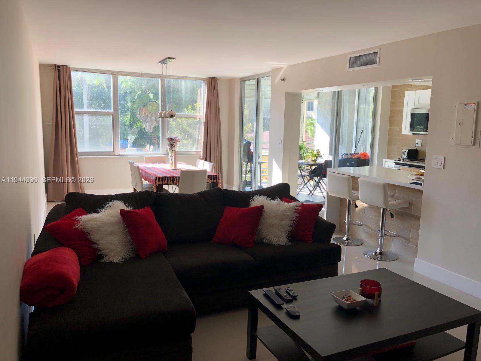 17890 West Dixie Highway, Unit 210 North Miami Beach, FL 33160 - Photo 10 of 19 a living room with furniture and a large window
