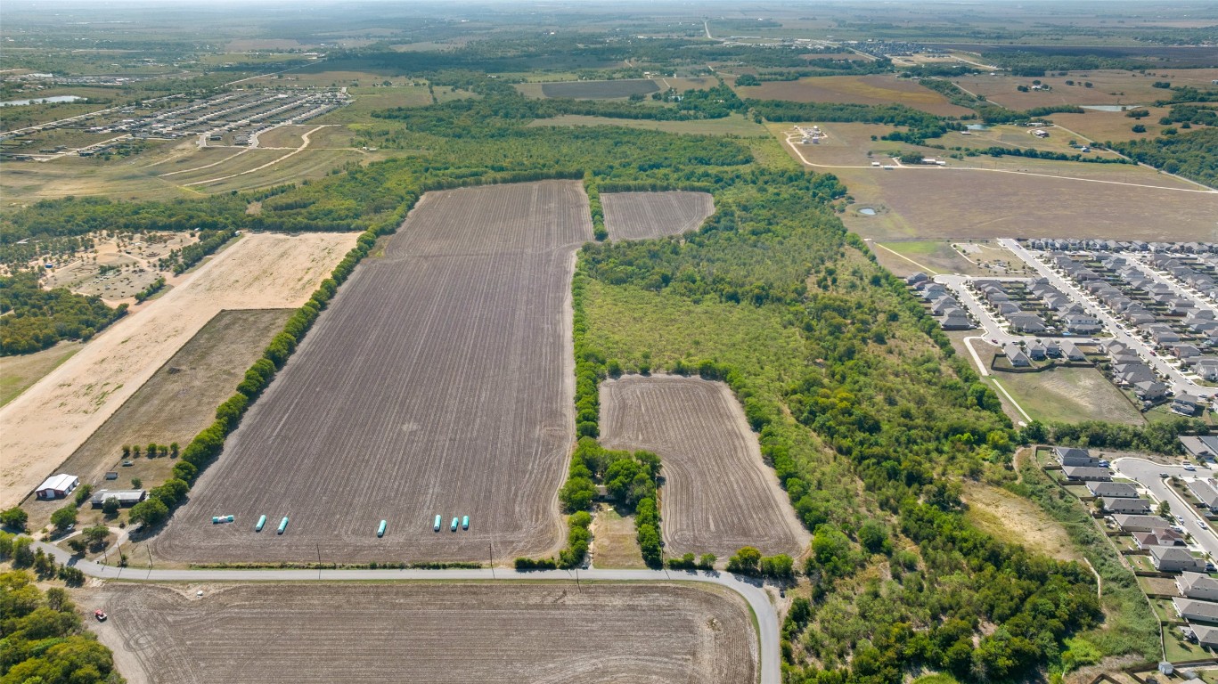 Dairy Dairy Road Kyle, TX 78640 - Photo 3 of 22 an aerial view of a house with a yard and lake view