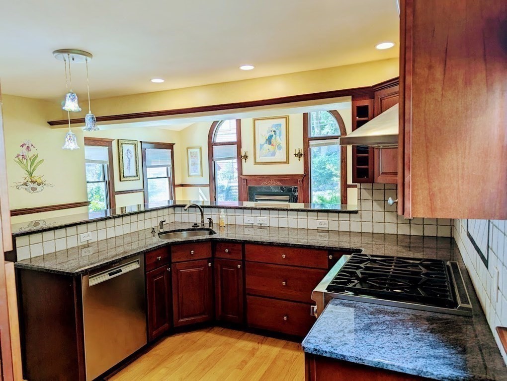 43 Brunswick Road Arlington, MA 02476 - Photo 12 of 42 a kitchen with granite countertop stainless steel appliances and wooden cabinets