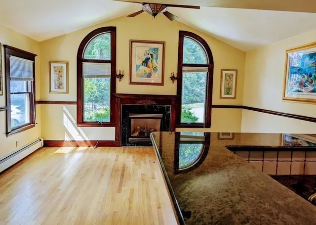 a view of an empty room with a fireplace and a window