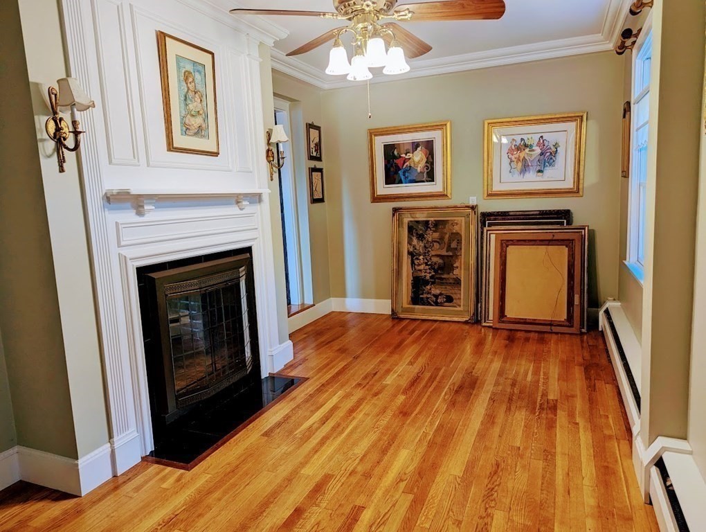 43 Brunswick Road Arlington, MA 02476 - Photo 16 of 42 a view of an empty room with wooden floor and a fireplace