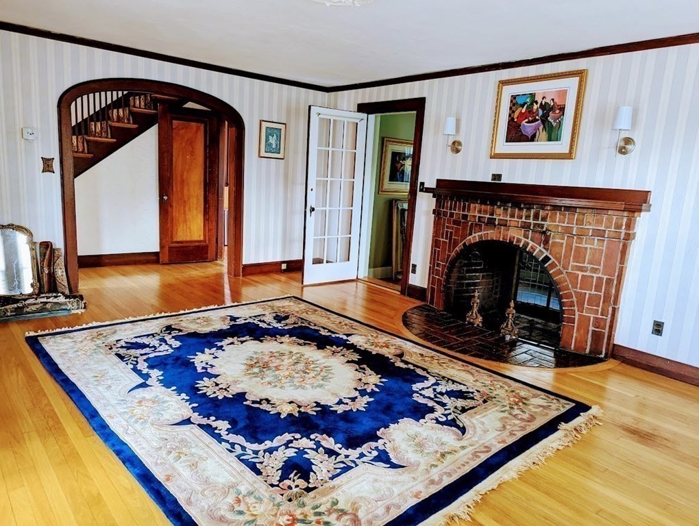 43 Brunswick Road Arlington, MA 02476 - Photo 18 of 42 a living room with furniture and a fireplace